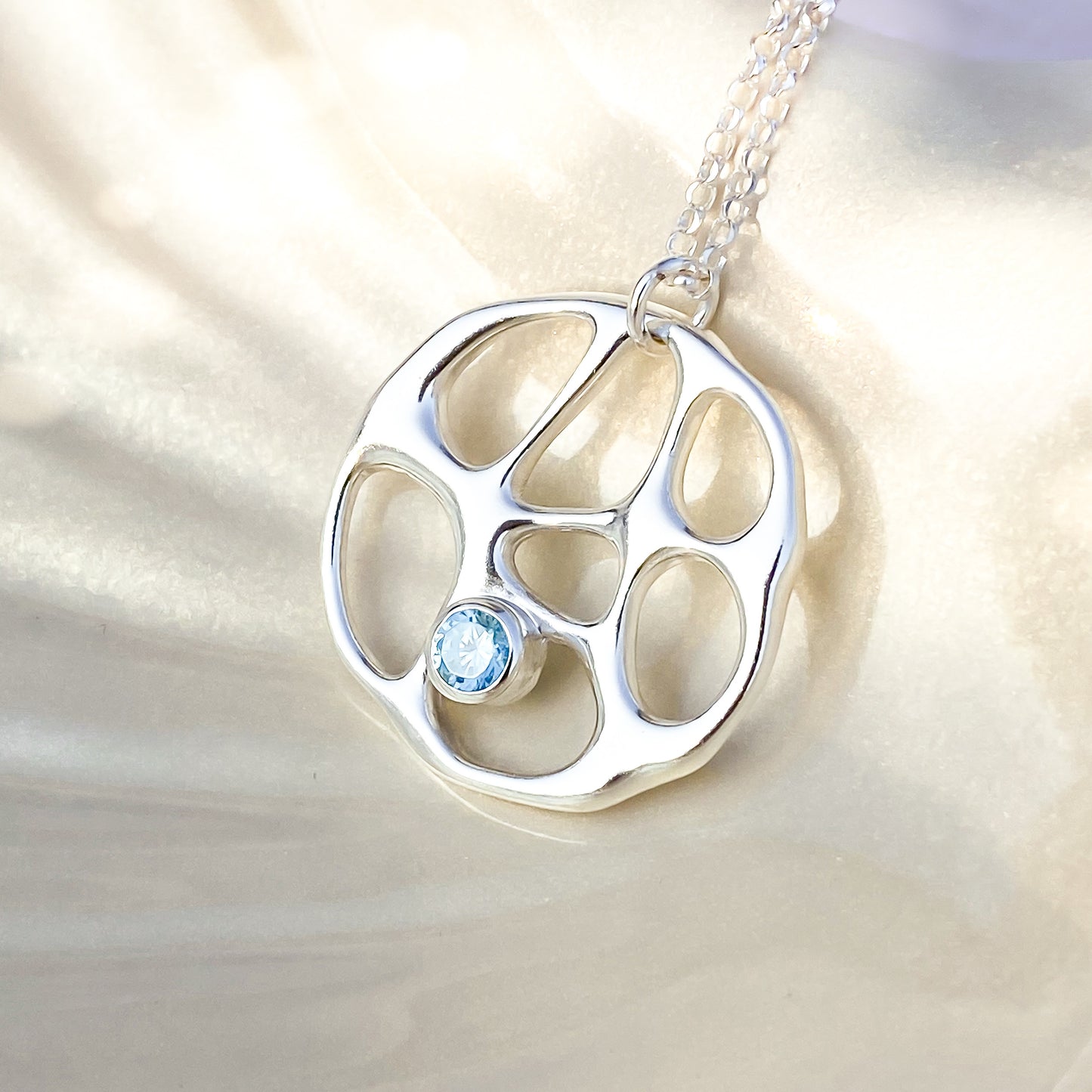 Silver Infinity Necklace with Blue Topaz